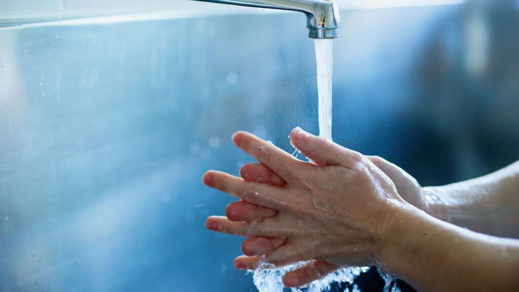  a kid washing his hands for high Hygiene